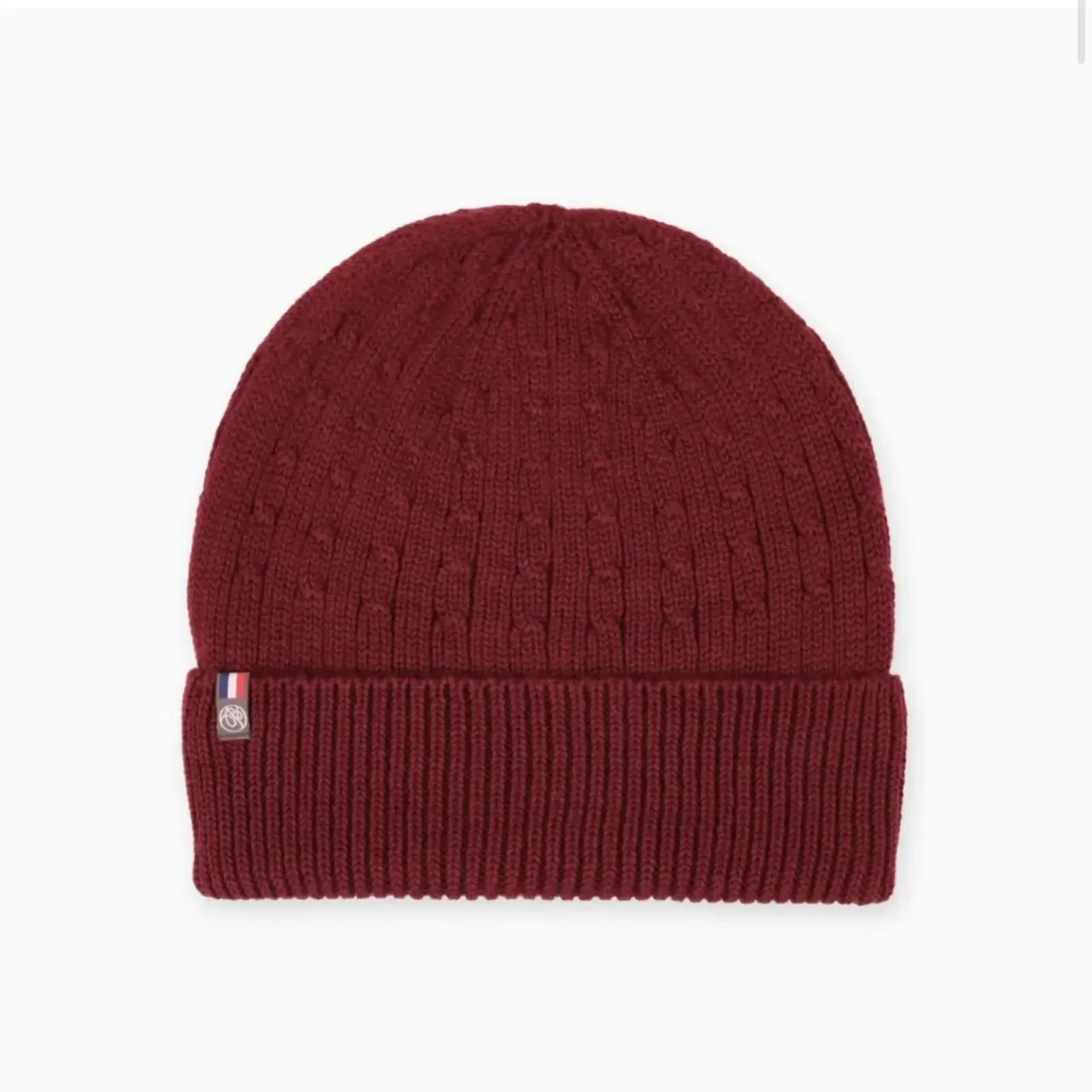 Bonnet rouge en maille côtelée présenté de face sur un fond clair.